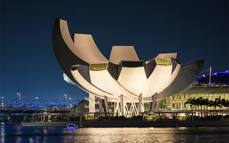 ArtScience Museum illuminated at night in Singapore.