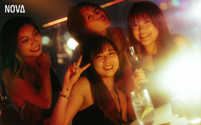 Friends enjoying wine and cocktails at Nova Bar.